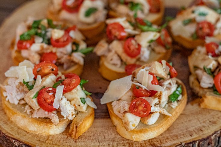 small appetizers are arranged on top of a wooden platter