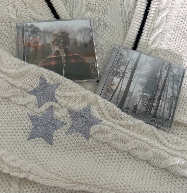 two photos are laying next to each other on a white knitted blanket with silver stars