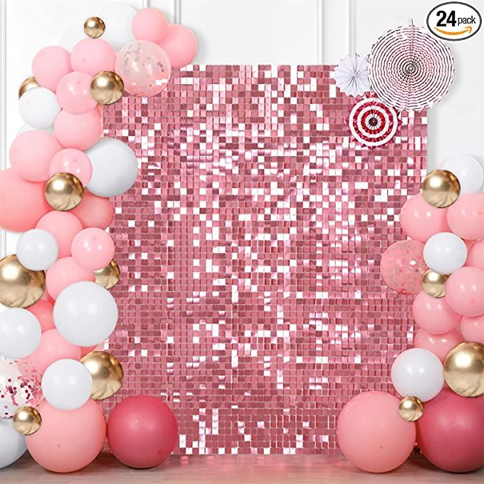 a pink and white backdrop with balloons