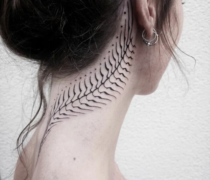 a woman with a tattoo on her neck