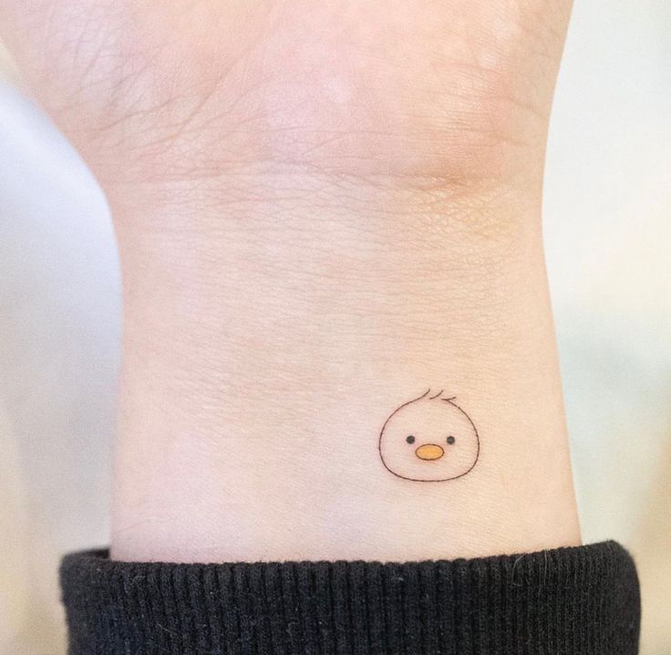 a small bird tattoo on the wrist