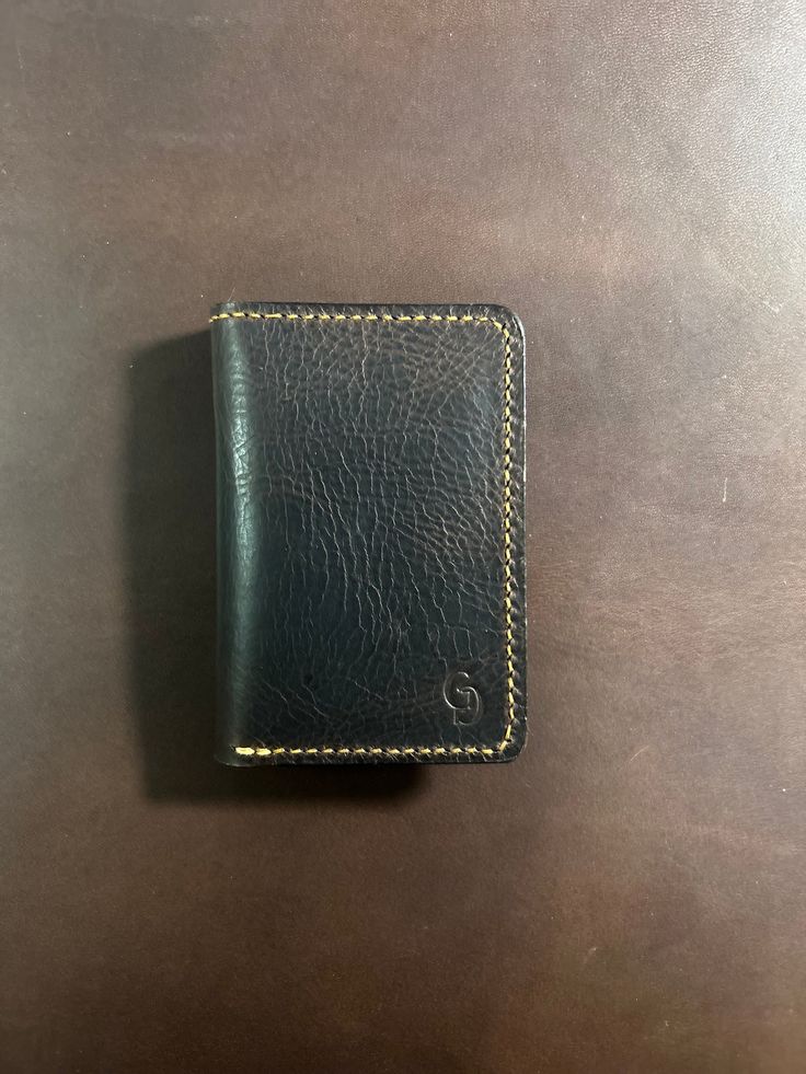 Full grain Italian leather made into a luxurious wallet designed to last generations. Handmade and hand sewn down to the last stitch. is able to fit 6-8 cards and cash! Black Leather Wallet Hand-stitched, Hand-stitched Black Leather Wallet, Hand-stitched Black Rectangular Wallet, Black Hand-stitched Rectangular Wallet, Black Rectangular Hand-stitched Wallets, Hand-stitched Trifold Wallet For Everyday Use, Hand-stitched Bifold Card Holder For Everyday Use, Hand-stitched Trifold Wallet, Classic Hand-stitched Wallets As Gifts