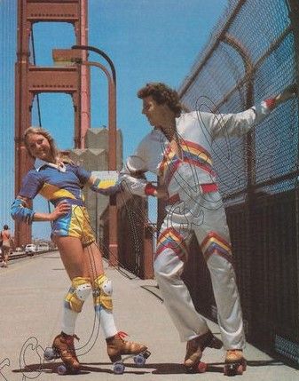 two people on roller skates in front of the golden gate bridge