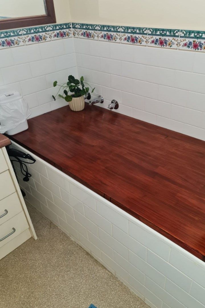 a wooden counter top in the corner of a room