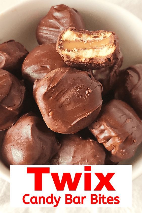 a bowl filled with chocolate covered candies next to the words twix candy bar bites