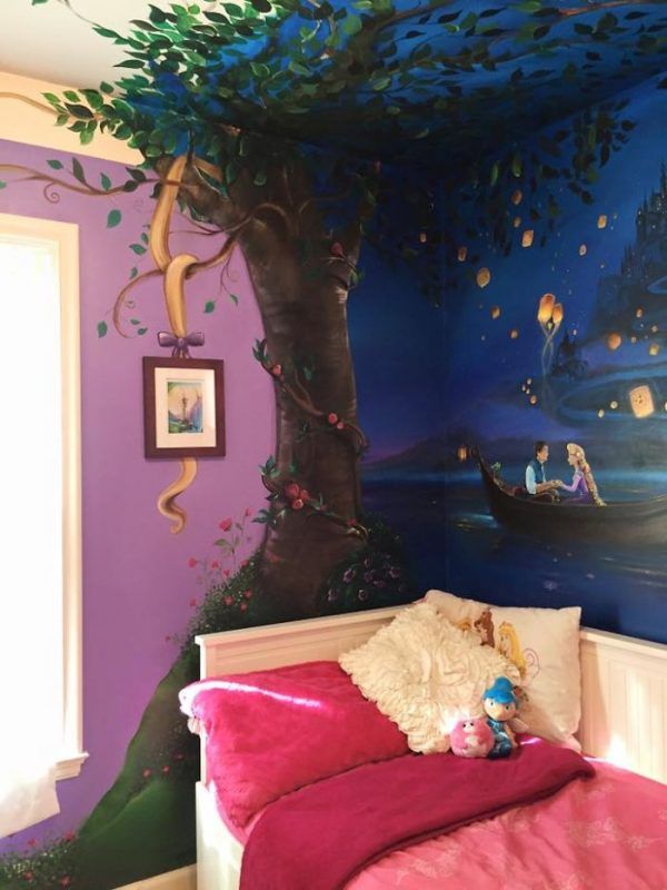 a child's bedroom decorated in purple and blue with a tree painted on the wall