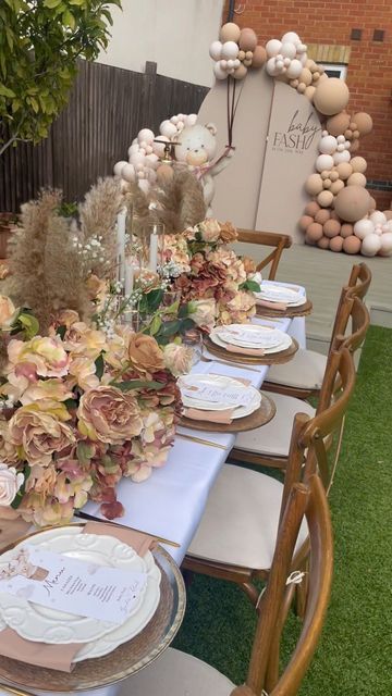 a table set up with flowers and plates