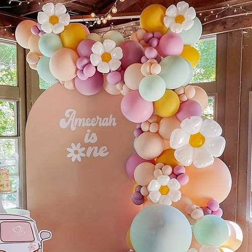 an arch made out of balloons and flowers