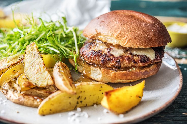 a sandwich and some potatoes on a plate