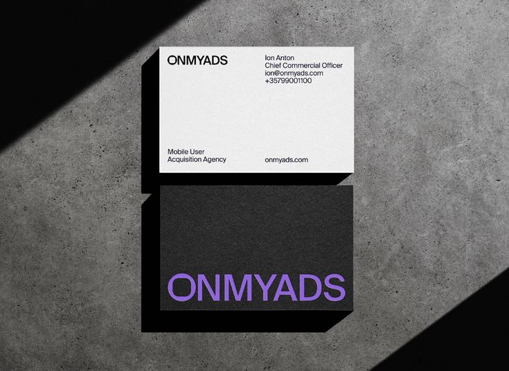 a business card with the word onmyads written in purple and black ink next to it