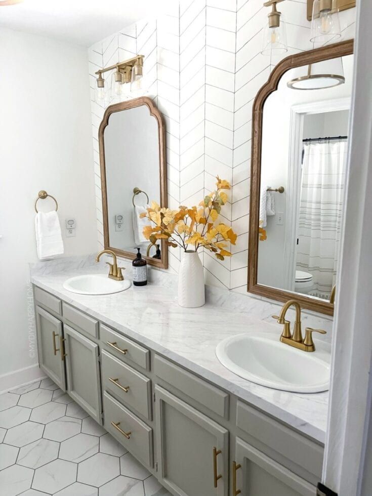 a bathroom with two sinks and mirrors in it