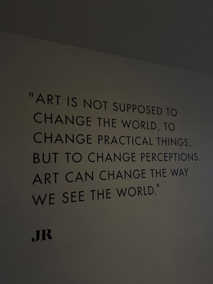 a black and white photo with a quote written on the wall above it that says art is not supposed to change the world, to change practical things, but to change