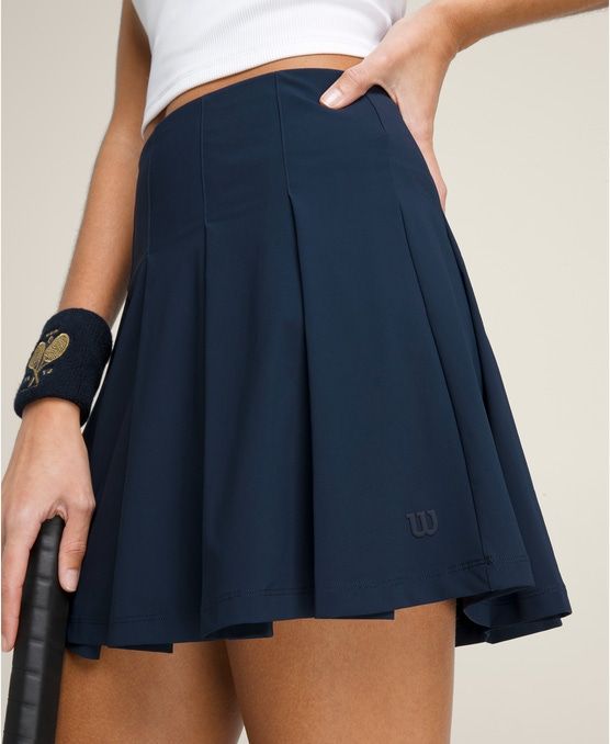 Classic Pleated Skirt | Wilson Sporting Goods Spring Pleated 4-way Stretch Tennis Skirt, Spring Pleated Tennis Skirt With 4-way Stretch, Classic Lined Tennis Skirt For Summer, Classic Summer Tennis Skirt With Relaxed Fit, Classic Summer Skort, Classic Solid Tennis Skirt For Spring, Navy Casual Tennis Skirt, Casual Spring Sports Pleated Skirt, Classic Summer Tennis Dress