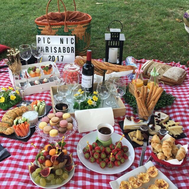 an outdoor picnic is set up with food and wine for guests to enjoy in the sun