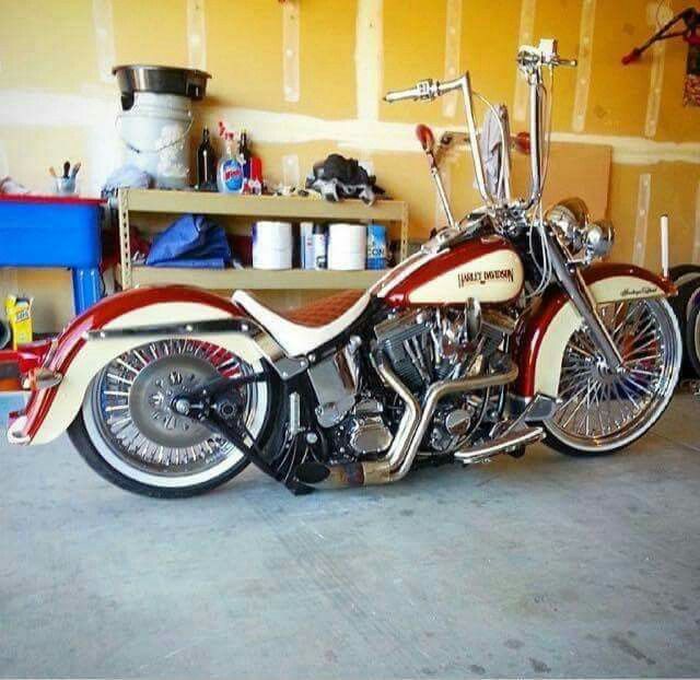 a red and white motorcycle parked in a garage