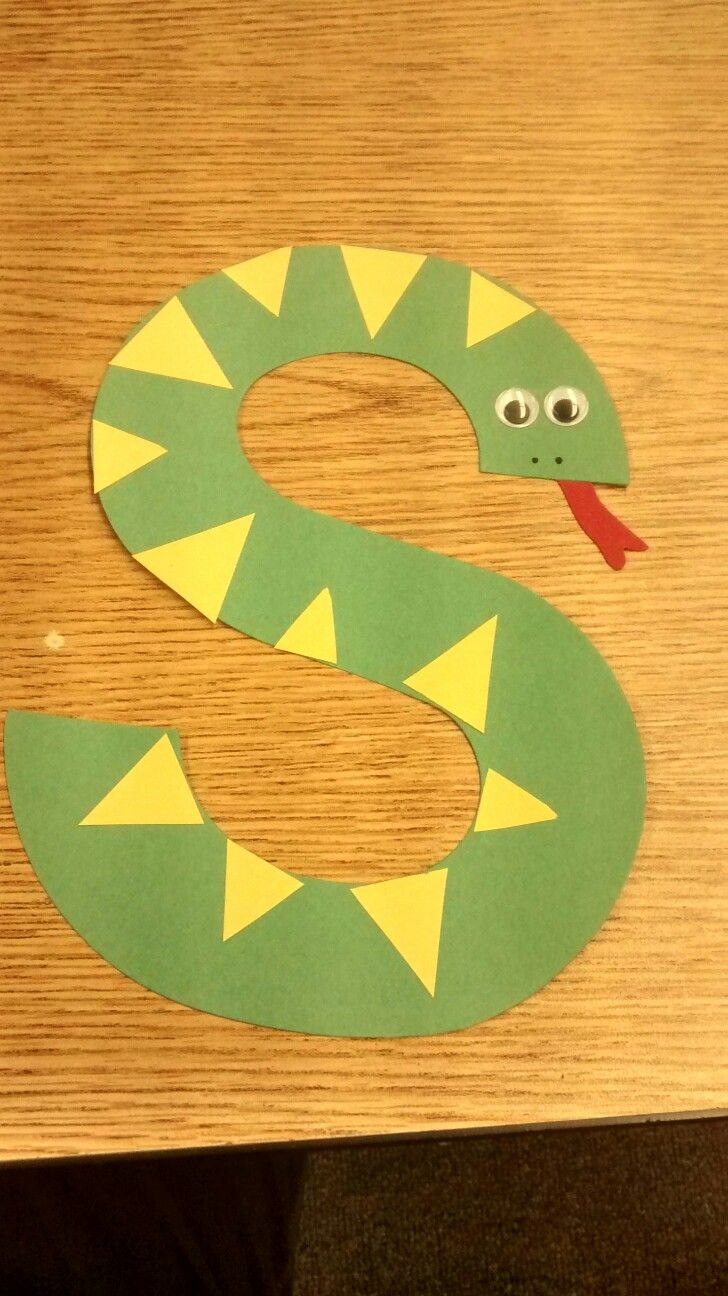 the letter s is made out of paper with a snake on it