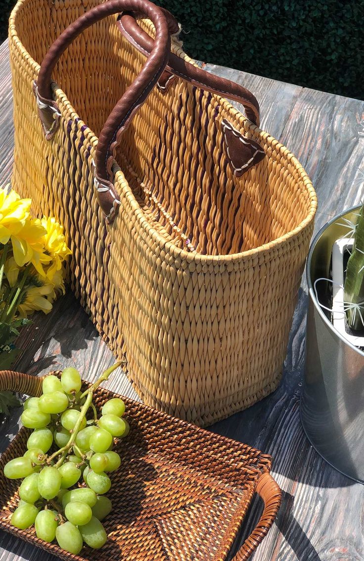 two wicker baskets sitting on top of a wooden table