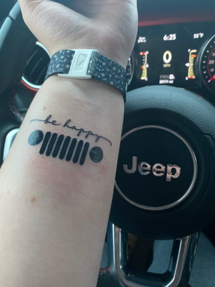 a person with a jeep tattoo on their arm and the word jeep written in cursive writing