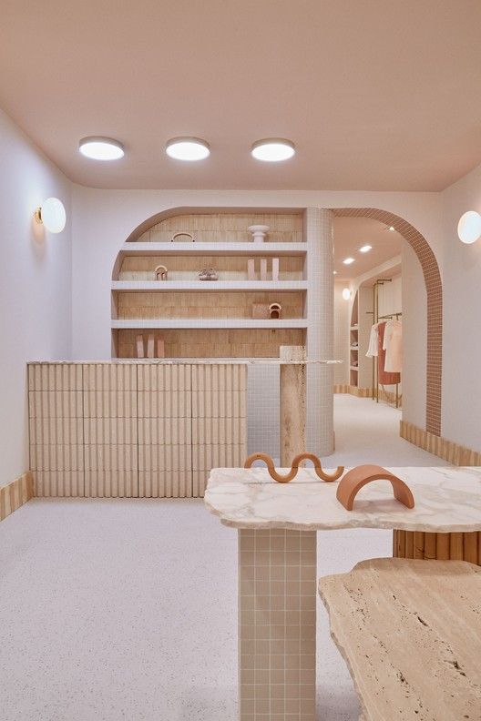 an empty room with wooden tables and shelves