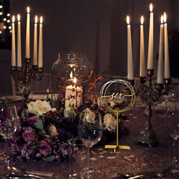 a table topped with lots of candles and flowers