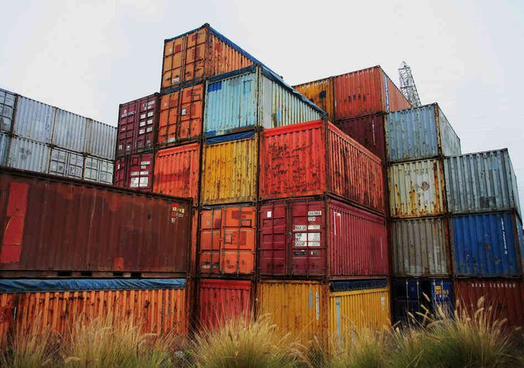 many different colored containers stacked on top of each other