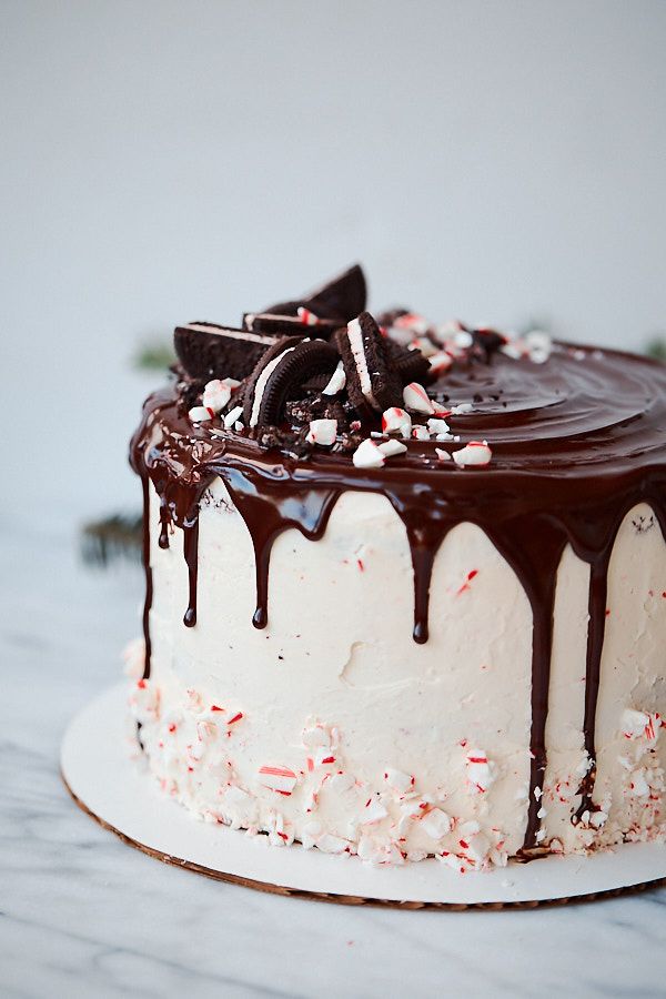 a chocolate cake with white frosting and sprinkles