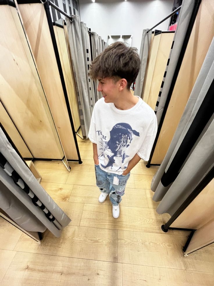 a young boy standing in the middle of a room with lots of doors on both sides