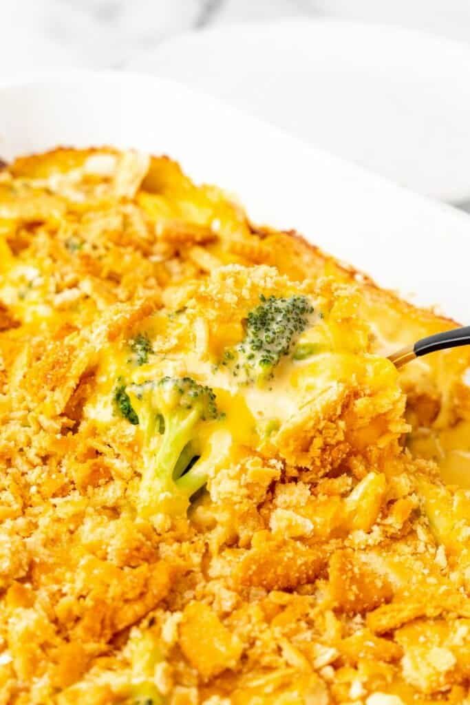 a casserole dish with broccoli and cheese in it on a white plate