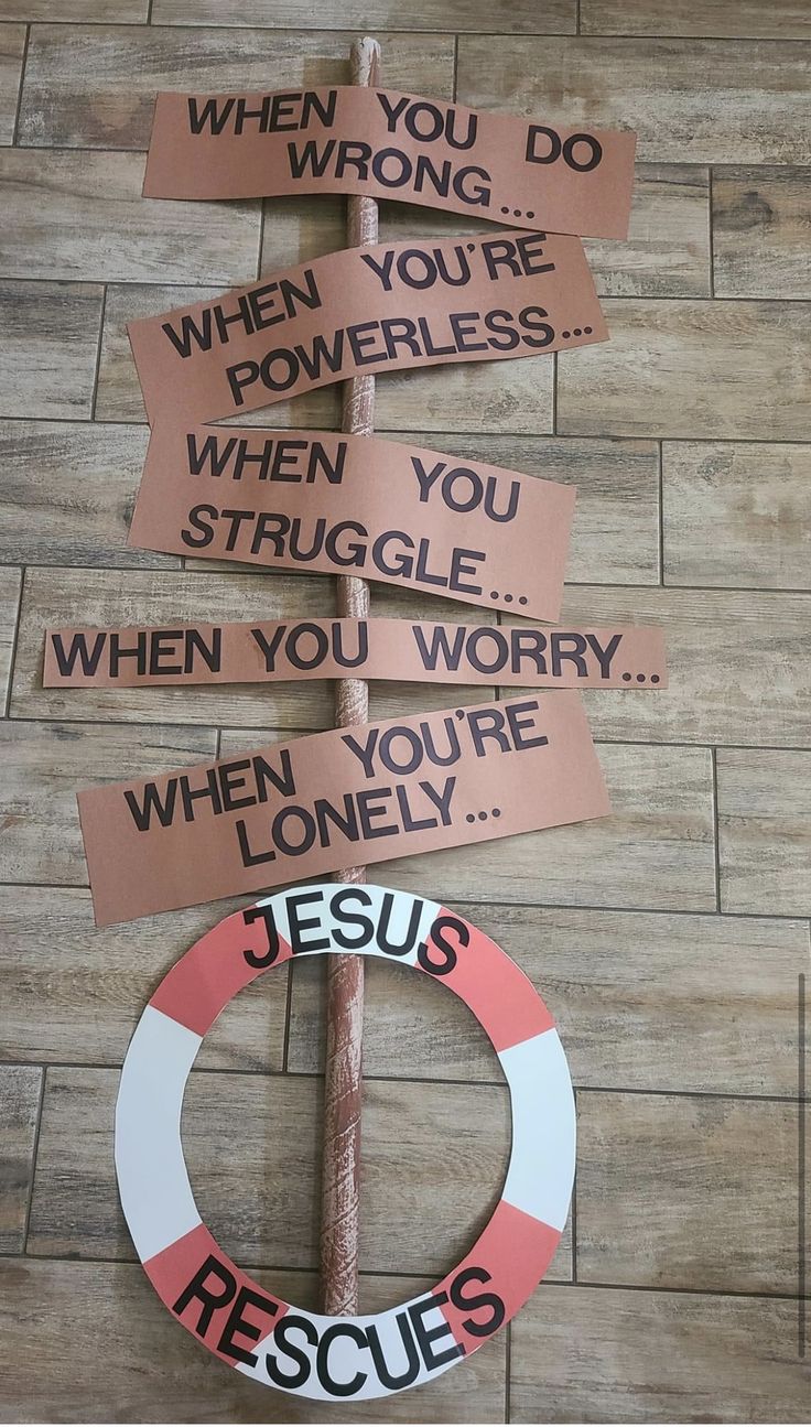 a sign that has been placed on top of a wooden floor with other signs attached to it