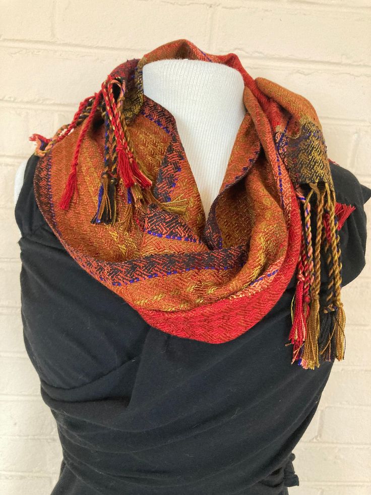 Each of my scarves is hand-dyed, hand-woven and one of a kind. I start with pure silk, then dye it, warp it, and weave it. The silk is exceptionally soft to the touch, with an elegant soft drape.  My scarves are lightweight, breathable, yet warm. They can be worn fall, winter, and spring and even on cool summer evenings.  They are finely woven, yet durable and long-lasting. They can be washed easily by hand with mild soap and warm water, or dry-cleaned. Red Bohemian Pashmina Scarves, Bohemian Red Pashmina Scarf, Red Pashmina Bohemian Scarf, Red Bohemian Scarf, Red Handmade Bohemian Shawl, Handmade Red Scarf For Fall, Handmade Red Scarves For Fall, Traditional Red Scarves For Fall, Handwoven Multicolor Scarves