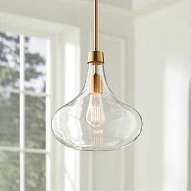 a glass light fixture hanging from a ceiling in a room with white walls and windows