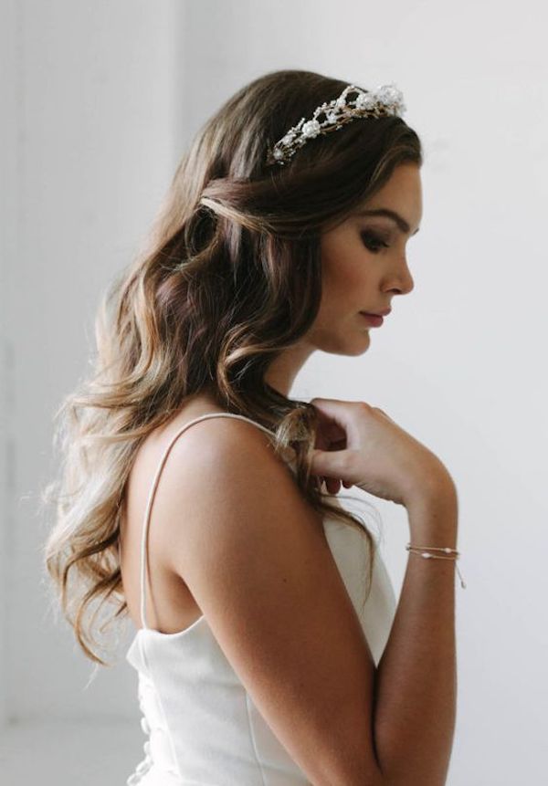 a woman with long hair wearing a white dress and a tiara on her head