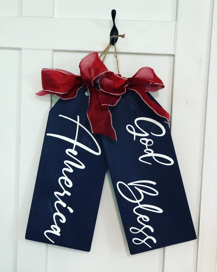 two door hangers decorated with red and blue ribbons