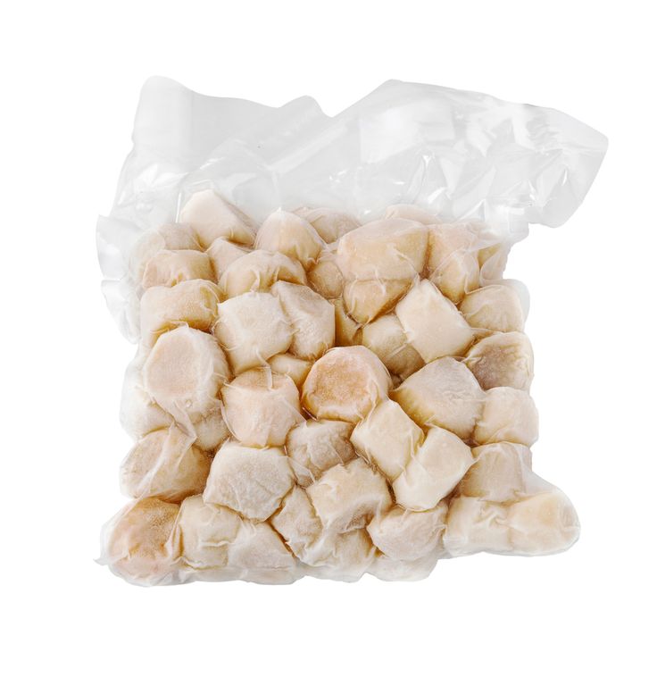 peeled chicken pieces in a plastic bag on a white background