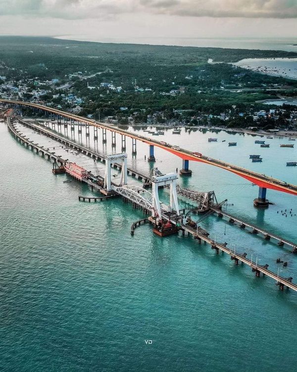 an aerial view of a bridge spanning the ocean