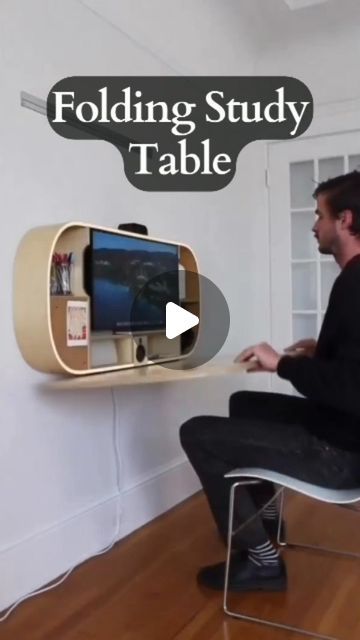 a man sitting on a chair in front of a computer monitor with the text folding study table