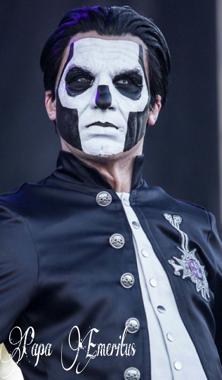 a man with white face paint and black hair