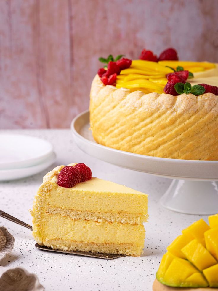 there is a piece of cake on the plate and another slice has raspberries