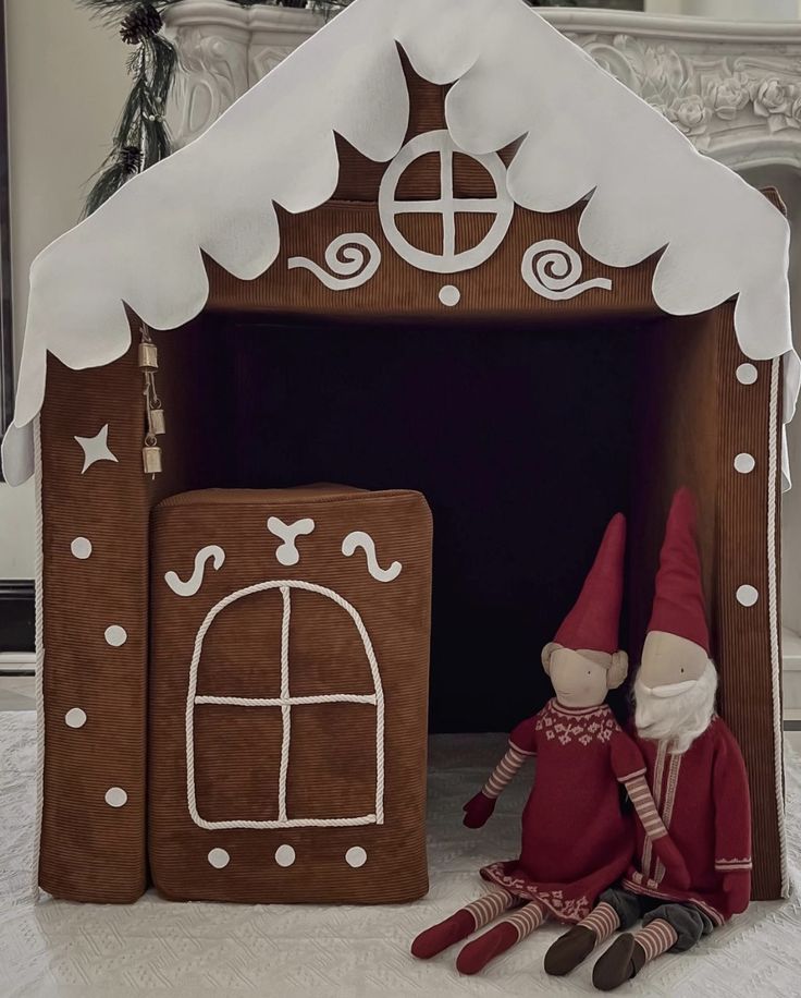 a gingerbread house with two gnomes in it