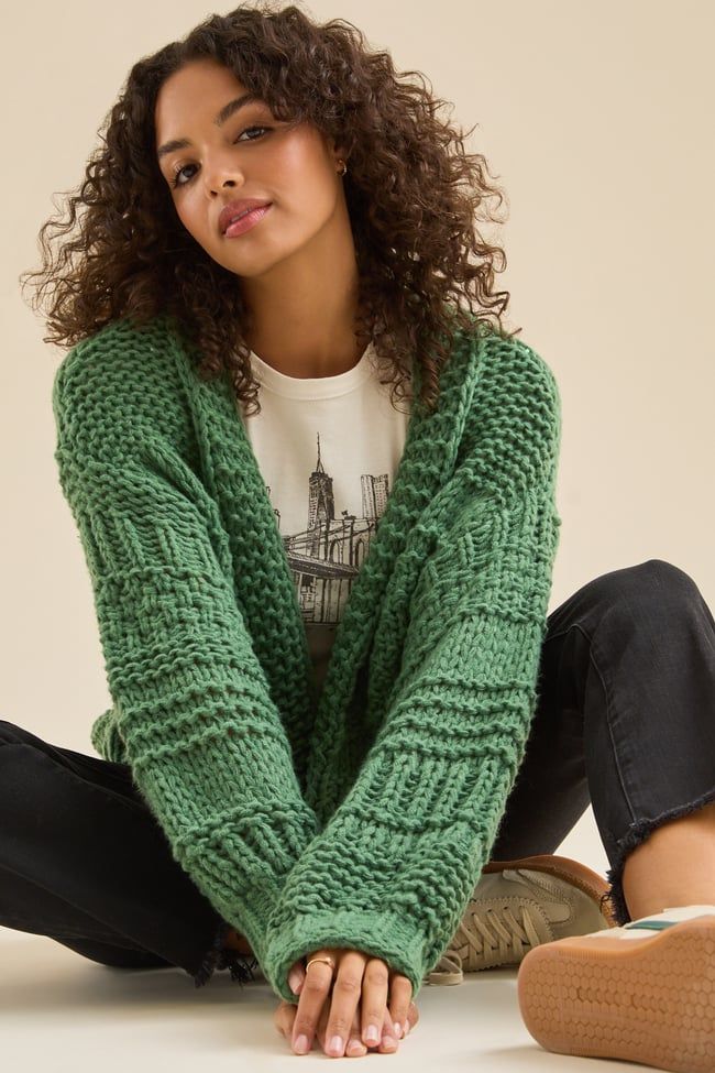 This cozy and stylish chunky textured cardigan is the perfect piece for your wardrobe. The soft fabric and oversized fit will keep you warm and comfortable all season long, while the textured design adds a touch of interest. Oversized Cozy Cardigan With Soft Texture, Trendy Oversized Soft Texture Cardigan, Chic Knit Cardigan With Soft Texture, Cozy Green Cable Knit Cardigan, Green Cable Knit Sweater Coat, Oversized Cozy Sweater Coat With Soft Texture, Green Knitted Cardigan For Cold Weather, Trendy Chunky Knit Cardigan For Loungewear, Textured Knit Cardigan For Loungewear