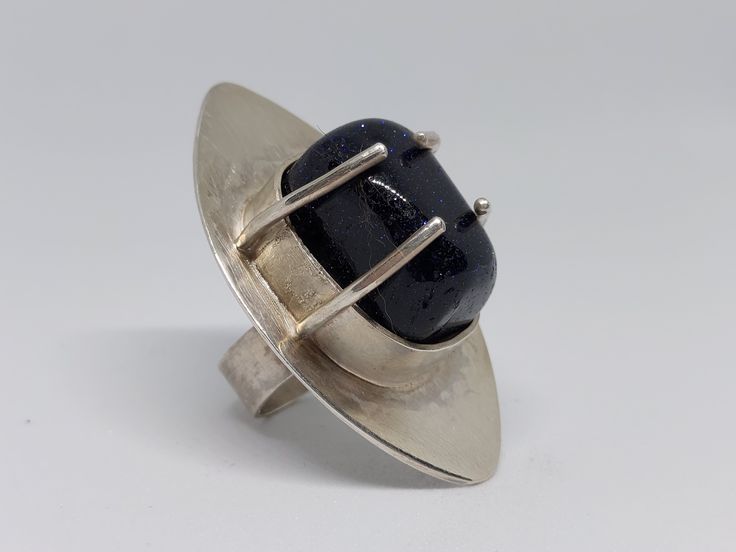 One-of-a-kind, handcrafted Sterling Silver ring with Blue Goldstone, Size 6 Modern Handmade Sterling Silver Dome Ring, Modern Handmade Dome Ring In Sterling Silver, Modernist Open Ring As A Gift, Modernist Open Ring As Gift, Modernist Open Ring For Gift, Modernist Open Ring Gift, Modernist Open Dome Ring As Gift, Modern Cabochon Sapphire Ring For Gift, Modernist Gemstone Ring Jewelry