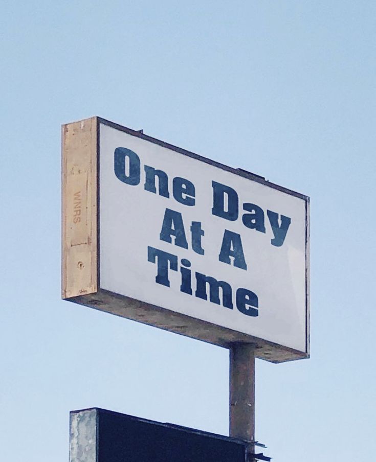 a sign that says one day at a time