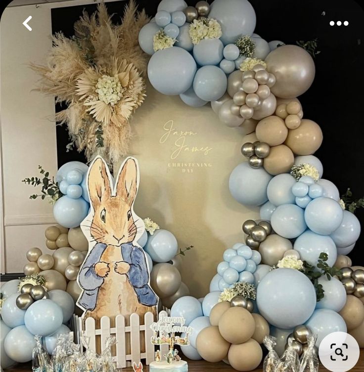 a table topped with lots of balloons and decorations