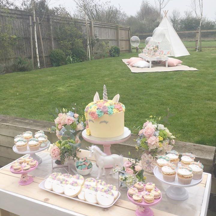 a table with cupcakes and cakes on it