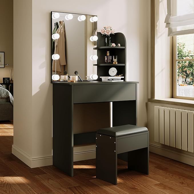 a dressing table with lights on it and a stool in front of the vanity mirror