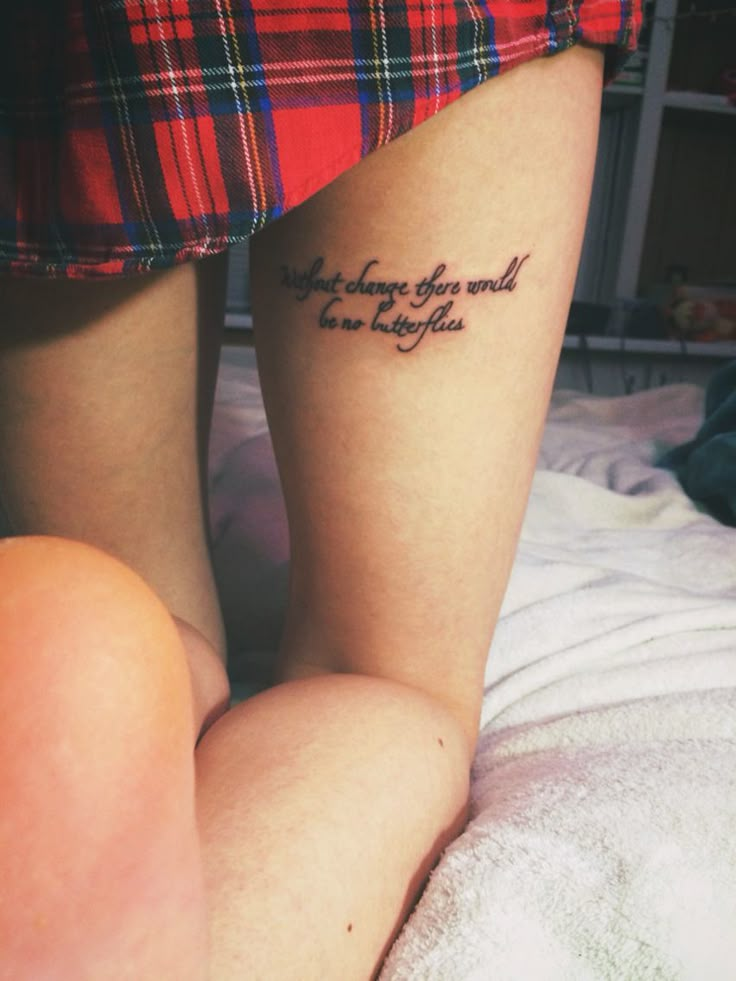 a woman with a tattoo on her leg that says, whatever is the end of everything