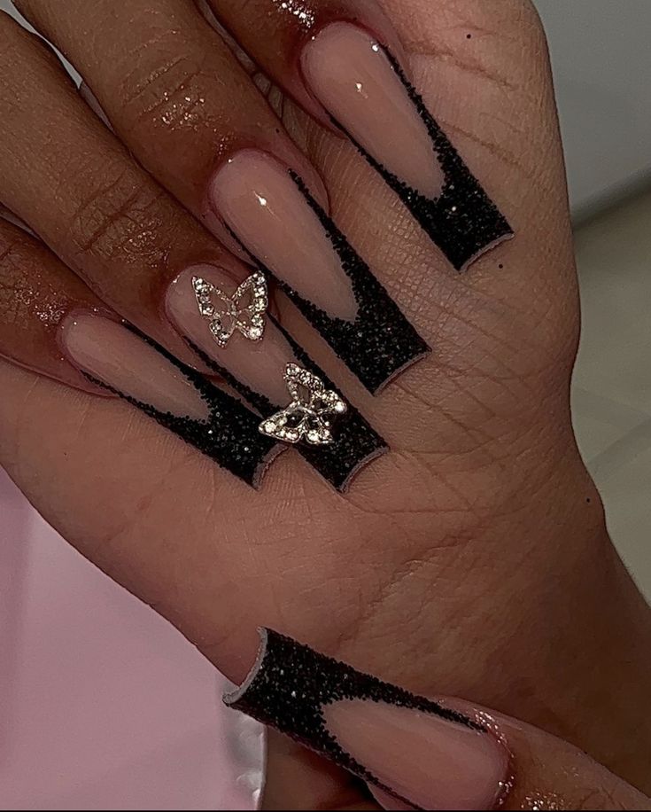 Black French Tip Nails With Butterfly Charm, Black Glitter Butterfly Nails, Black Nails Acrylic Birthday, Red And Black Glitter Nails Acrylic, Black Nail Sets Coffin, Black Nails With Butterfly Design, Cute Black And Silver Nails, Black 15 Nails, Black Nail Looks