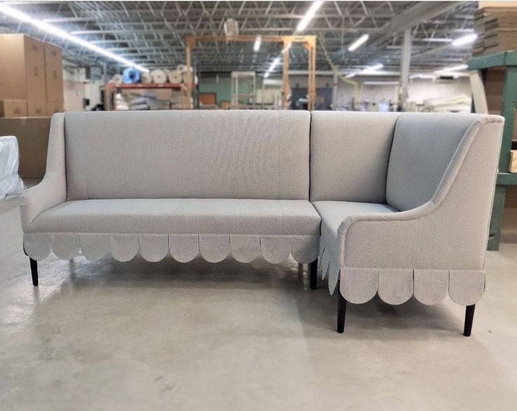 a couch with scalloped edges in a warehouse