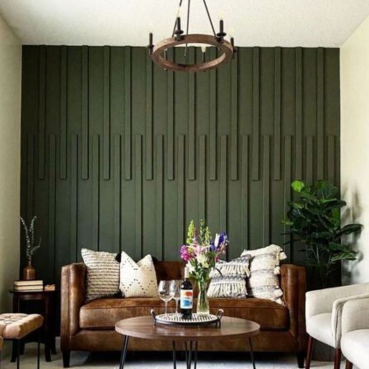 a living room with two couches and a coffee table in front of a green paneled wall