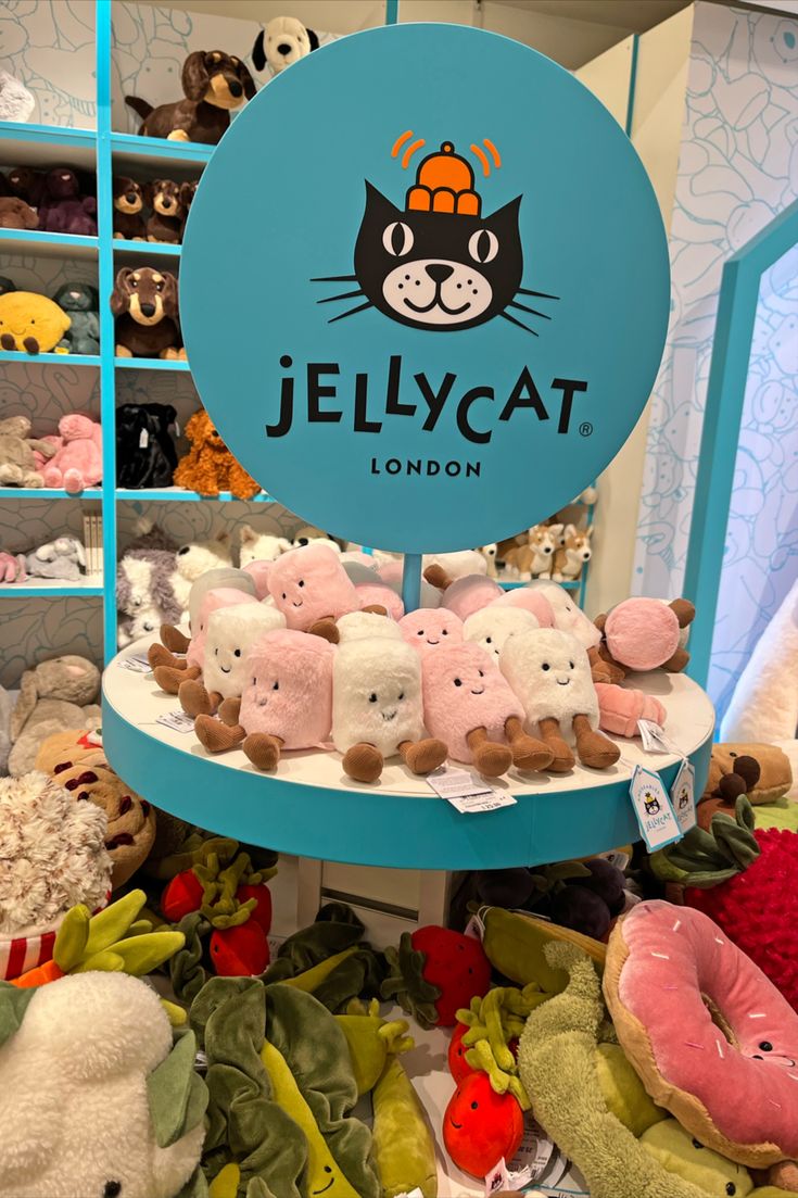 there are many stuffed animals on display in the store and one is for jellycat